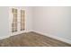 Empty room featuring stylish French doors and wood flooring at 816 Still Willow Ln, Wendell, NC 27591