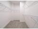 A walk-in closet with carpeted floors and multiple wire rack shelving units to maximize storage space at 816 Still Willow Ln, Wendell, NC 27591