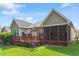 Charming home showcasing a deck and screened in porch in a landscaped backyard at 913 S South Bend Dr, Durham, NC 27713