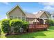 Charming home showcasing a wooden deck, well-manicured lawn, and mature landscaping at 913 S South Bend Dr, Durham, NC 27713