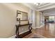 Elegant foyer featuring hardwood floors, console table, and a view of the bookcase and living room at 913 S South Bend Dr, Durham, NC 27713