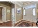 Bright foyer with hardwood floors, decorative rug, and a view of the entryway and a bedroom at 913 S South Bend Dr, Durham, NC 27713