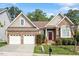 Charming single-story home featuring a two-car garage, brick facade, and inviting front garden at 913 S South Bend Dr, Durham, NC 27713
