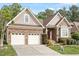 Charming single-story home featuring a two-car garage, brick facade, and inviting front garden at 913 S South Bend Dr, Durham, NC 27713