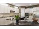 View of the kitchen with granite countertops, appliances and white cabinets at 913 S South Bend Dr, Durham, NC 27713