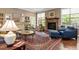 Comfortable living room with stone fireplace, windows, and seating at 913 S South Bend Dr, Durham, NC 27713