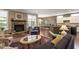 Inviting living room with a stone fireplace, hardwood floors, and an open view of the kitchen and dining area at 913 S South Bend Dr, Durham, NC 27713