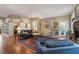 Open-concept living area with hardwood floors, fireplace, and an open view of the study at 913 S South Bend Dr, Durham, NC 27713