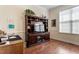Inviting living room with hardwood floors, built-in shelving, and a large television at 913 S South Bend Dr, Durham, NC 27713
