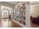 Open-concept living area with hardwood floors, built-in bookshelves, and a view of the front door at 913 S South Bend Dr, Durham, NC 27713