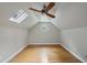 Attic bedroom featuring hardwood floors, skylight and a round window at 927 Jones Wynd, Wake Forest, NC 27587