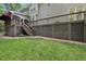 Backyard view of a home featuring a spacious deck and landscaped yard at 927 Jones Wynd, Wake Forest, NC 27587