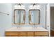 Bright bathroom featuring a double vanity with decorative framed mirrors at 927 Jones Wynd, Wake Forest, NC 27587
