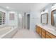Bathroom featuring a soaking tub, stand up shower, and double vanity at 927 Jones Wynd, Wake Forest, NC 27587