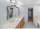 Light and airy bathroom with double vanity, decorative mirror, and access to connecting rooms at 927 Jones Wynd, Wake Forest, NC 27587