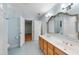 Bright bathroom with a double sink vanity, tile floors, and an ornate decorative mirror at 927 Jones Wynd, Wake Forest, NC 27587