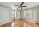 Bright bedroom with hardwood floors, ceiling fan, and natural light from double windows at 927 Jones Wynd, Wake Forest, NC 27587