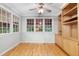 Bedroom features hardwood floors, built-in shelving, and large windows at 927 Jones Wynd, Wake Forest, NC 27587