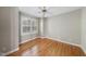 Well-lit bedroom featuring hardwood floors, neutral walls, and a bright double window at 927 Jones Wynd, Wake Forest, NC 27587