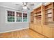 Bedroom features hardwood floors, built-in shelving, and multiple windows at 927 Jones Wynd, Wake Forest, NC 27587
