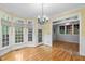 Bright dining area boasts multiple windows and a door to the outdoor deck at 927 Jones Wynd, Wake Forest, NC 27587