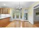Charming dining area with hardwood floors, chandelier, and large windows providing ample natural light at 927 Jones Wynd, Wake Forest, NC 27587