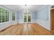 Elegant dining room featuring hardwood floors, decorative molding, and double doors to a porch at 927 Jones Wynd, Wake Forest, NC 27587