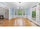 Charming dining room with natural light, hardwood floors, wainscoting, and backyard views at 927 Jones Wynd, Wake Forest, NC 27587