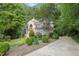 Charming two-story home featuring stone accents, lush landscaping, and a winding driveway at 927 Jones Wynd, Wake Forest, NC 27587