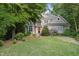 Inviting home with manicured lawn, blooming bushes, and a classic wood front door at 927 Jones Wynd, Wake Forest, NC 27587