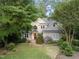 Charming two-story home with brick accents, complemented by lush landscaping and mature trees at 927 Jones Wynd, Wake Forest, NC 27587