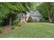 Beautiful home with lush lawn, mature trees, and meticulous landscaping at 927 Jones Wynd, Wake Forest, NC 27587