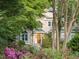 Charming home exterior boasts a well-maintained lawn, blooming flowers, and inviting front entrance at 927 Jones Wynd, Wake Forest, NC 27587