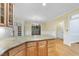 Open kitchen with light wood cabinets, granite island, hardwood floors, and sunny paint at 927 Jones Wynd, Wake Forest, NC 27587