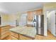 Open kitchen featuring an island, stainless steel appliances, and bright yellow paint at 927 Jones Wynd, Wake Forest, NC 27587