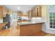 Bright kitchen features granite countertops, wood cabinets, and stainless steel appliances at 927 Jones Wynd, Wake Forest, NC 27587
