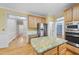 Modern kitchen with stainless steel appliances, granite countertops, and natural wood cabinets at 927 Jones Wynd, Wake Forest, NC 27587