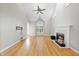 Spacious living room features hardwood floors, a fireplace, and large windows at 927 Jones Wynd, Wake Forest, NC 27587