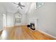 Living room features vaulted ceilings, hardwood floors, and a fireplace at 927 Jones Wynd, Wake Forest, NC 27587