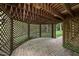 Covered outdoor patio features lattice trim, brick pavers, and provides shade from the sun at 927 Jones Wynd, Wake Forest, NC 27587