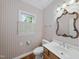 Charming powder room featuring a single sink vanity and hardwood floors at 927 Jones Wynd, Wake Forest, NC 27587