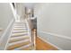 Bright foyer with a classic staircase, hardwood floors, and elegant trim details throughout at 927 Jones Wynd, Wake Forest, NC 27587