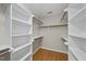 Spacious walk-in closet with custom shelving and wood floor at 927 Jones Wynd, Wake Forest, NC 27587