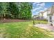 Lush backyard with retaining wall, patio, and a manicured lawn at 1003 Red Sunset Dr, Apex, NC 27502