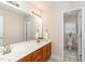 Bathroom featuring double sinks, bright lighting, and neutral tile at 1003 Red Sunset Dr, Apex, NC 27502
