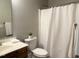 Well-lit bathroom featuring a white shower curtain and gray walls at 1003 Red Sunset Dr, Apex, NC 27502