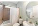 Cozy bathroom featuring a tub, tile surround, and round mirror at 1003 Red Sunset Dr, Apex, NC 27502