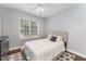 Comfortable bedroom with a large window, wood floors, neutral walls, and closet at 1003 Red Sunset Dr, Apex, NC 27502