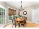 Inviting dining area with a wooden table, seating for six, wood floors and lots of natural light at 1003 Red Sunset Dr, Apex, NC 27502