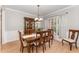 Dining room with wood table, buffet and decorative chandelier, adjacent to the kitchen at 1003 Red Sunset Dr, Apex, NC 27502